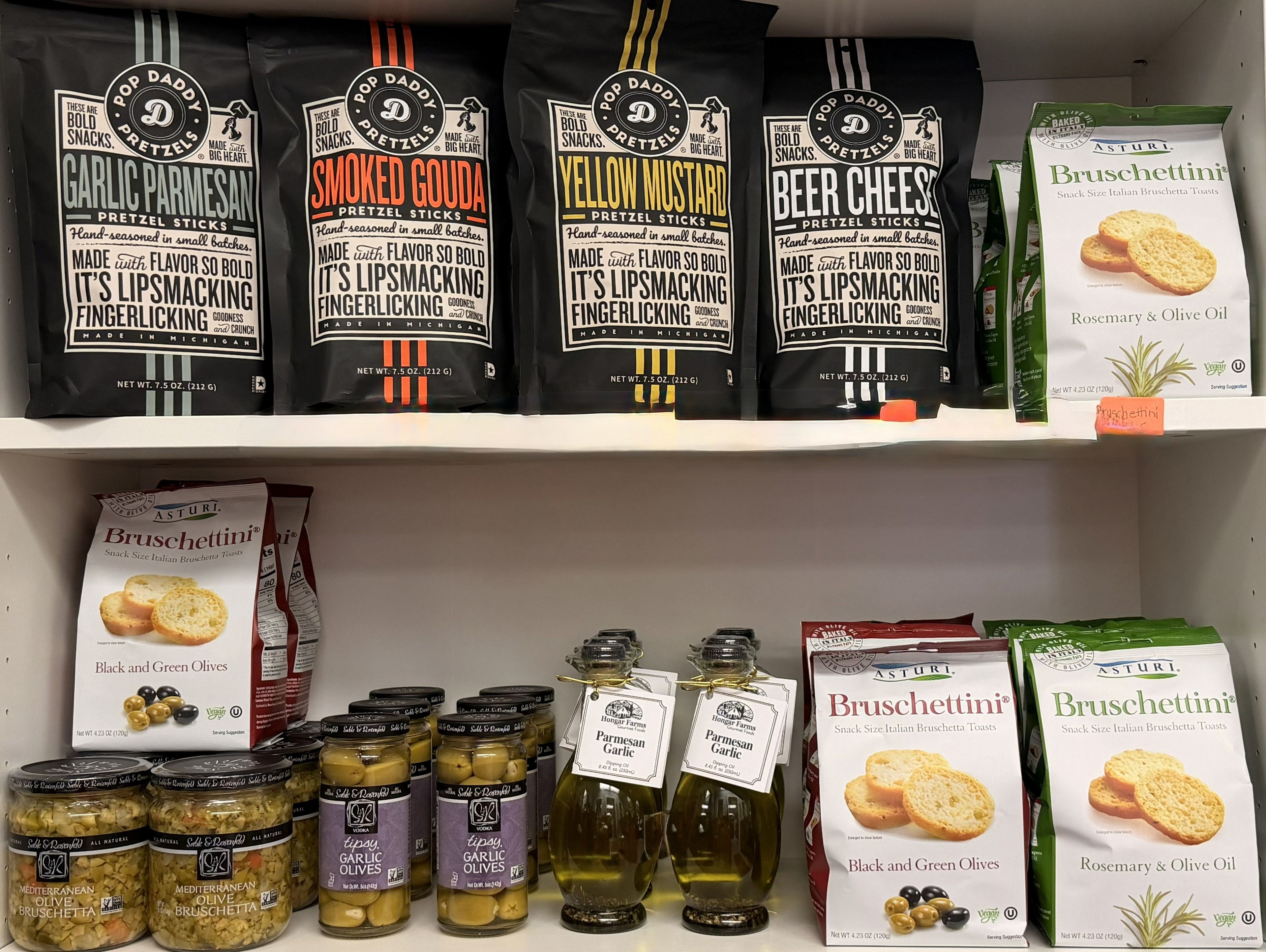 Artisan pretzels, bruschettini, garlic olives, and dipping oils on display