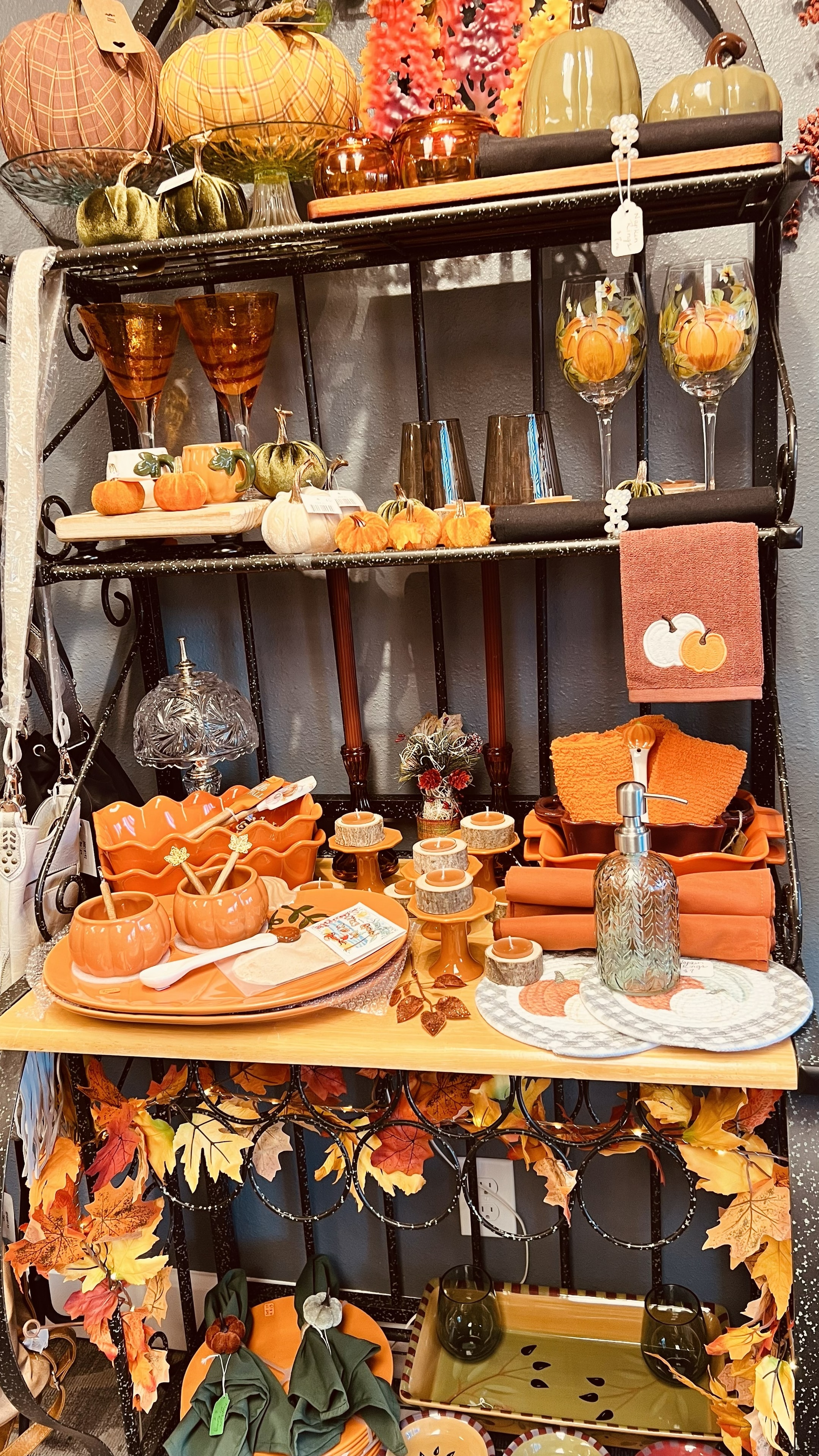 Autumn themed decorative shelf display with amber glassware and harvest accents
