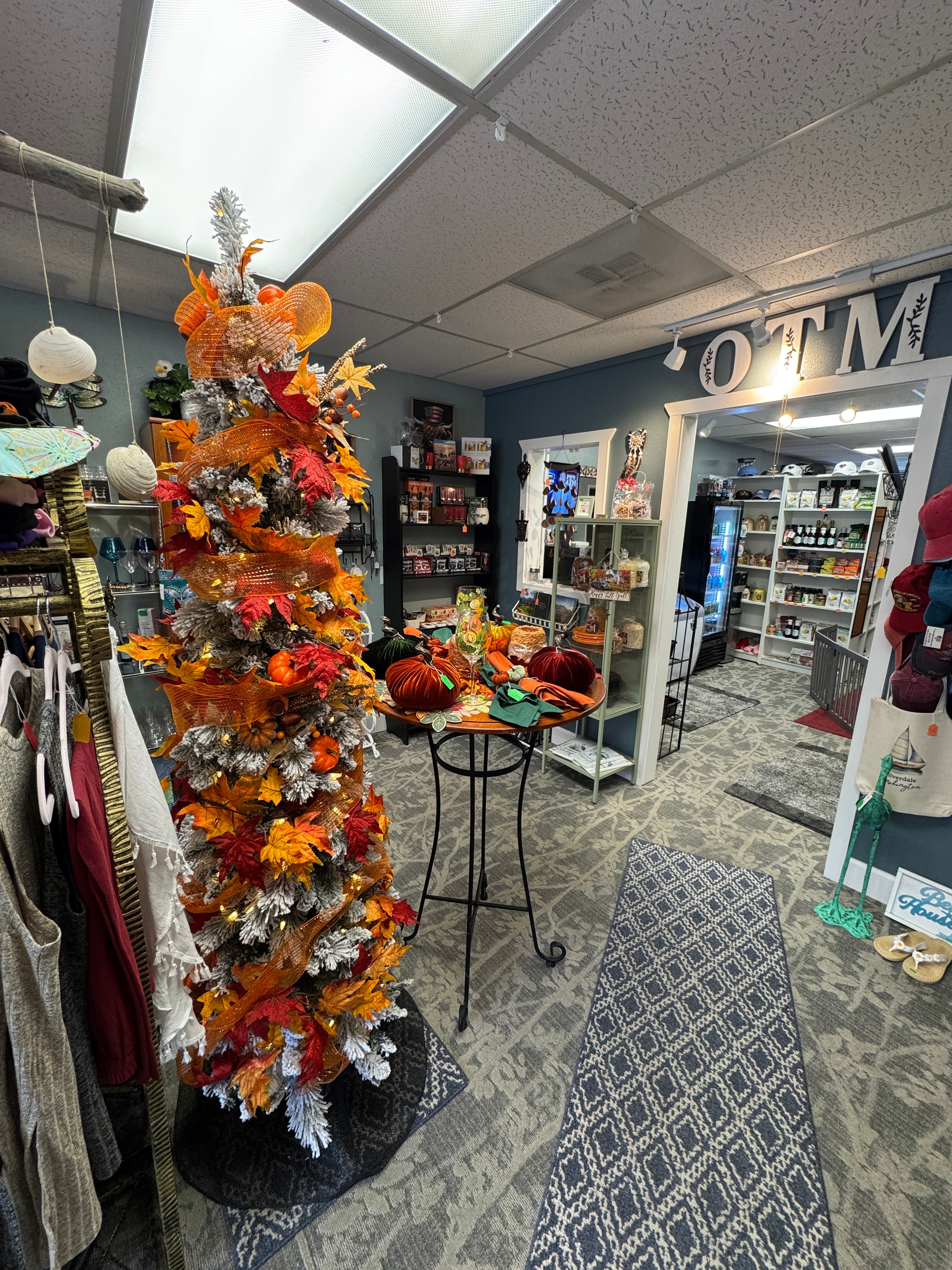 Wide interior view of Old Town Mercantile with fall garland centerpiece and full store display