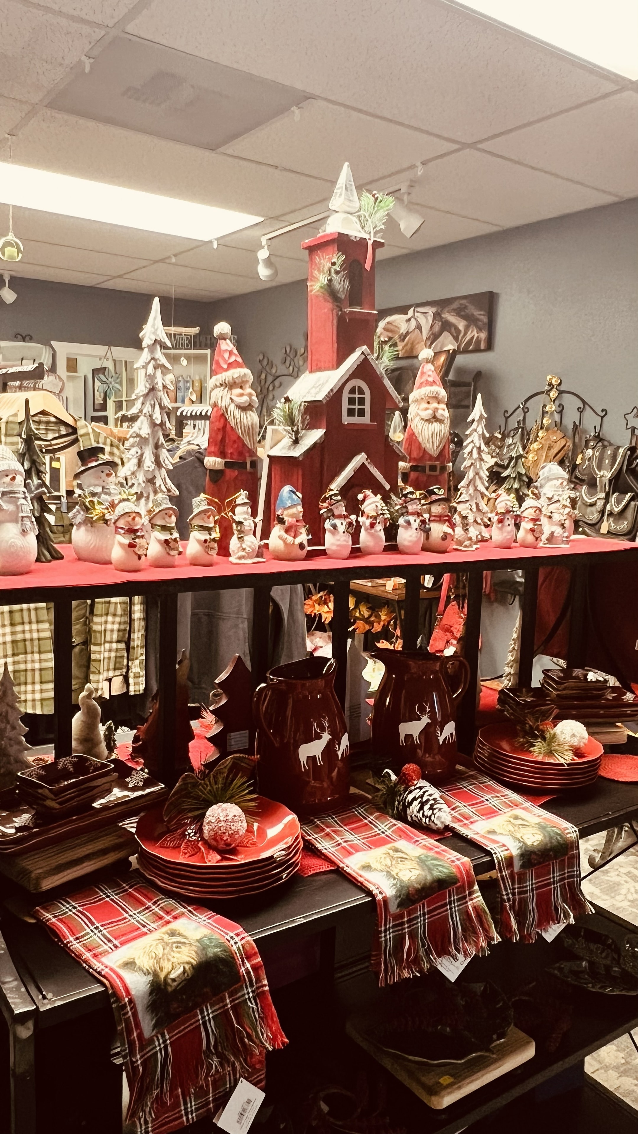 Christmas display with Santas, snowmen figurines, and reindeer tableware