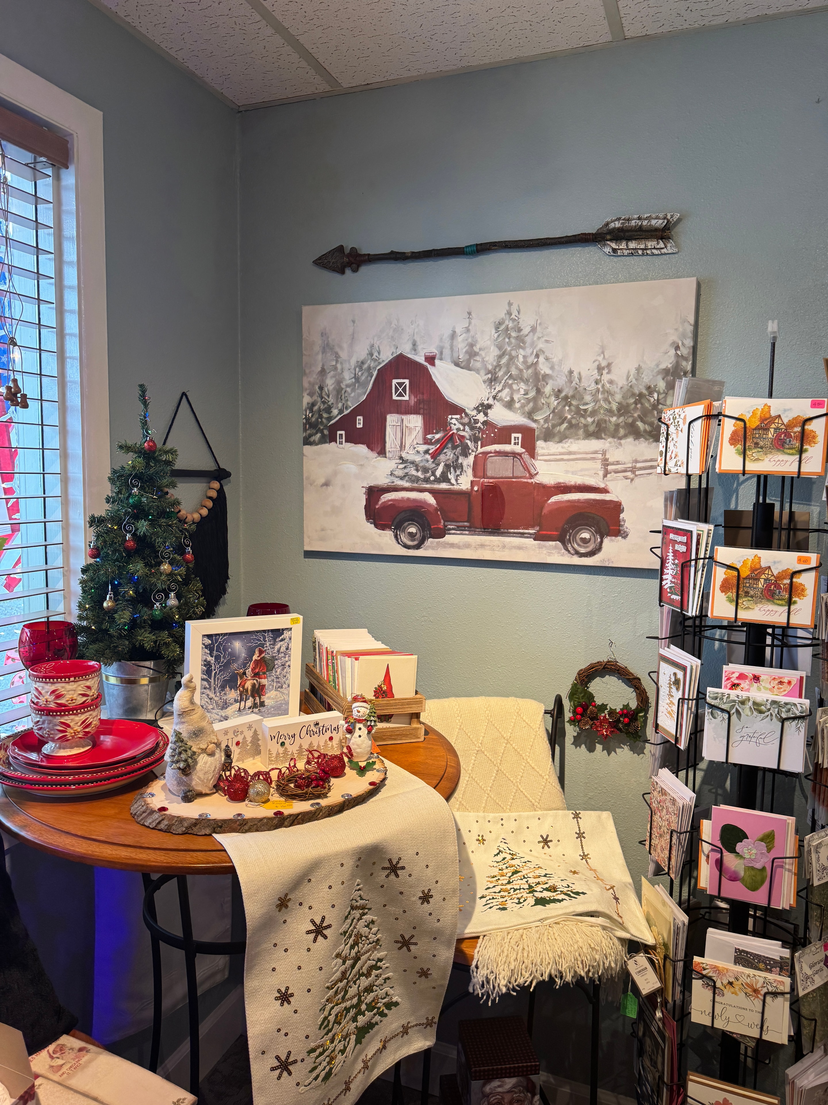 Full store Christmas display at Old Town Mercantile with vintage red truck, decorated trees, ornaments, and holiday merchandise throughout