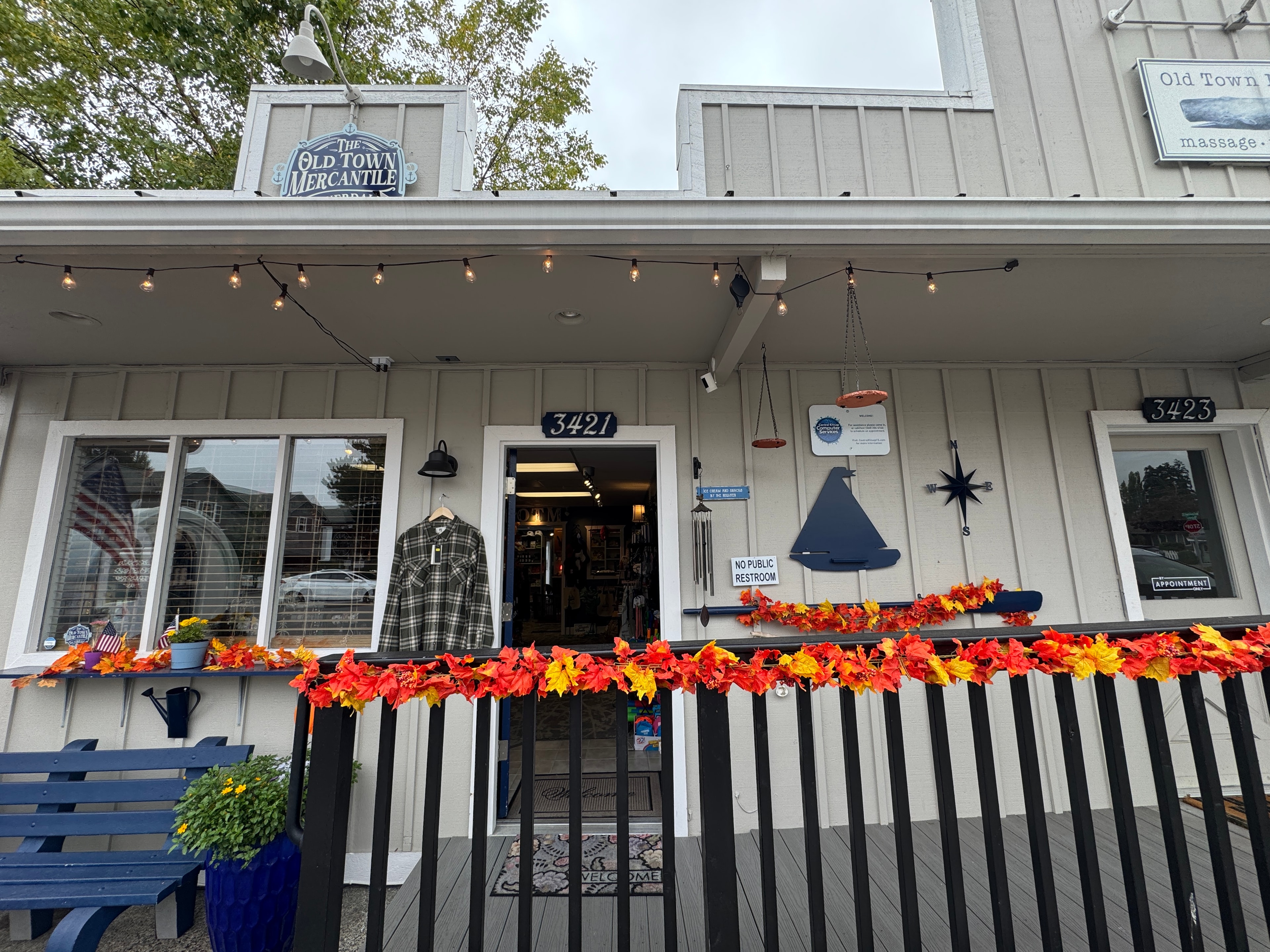 Old Town Mercantile storefront at 3421 NW Byron Street decorated with fall garland and string lights